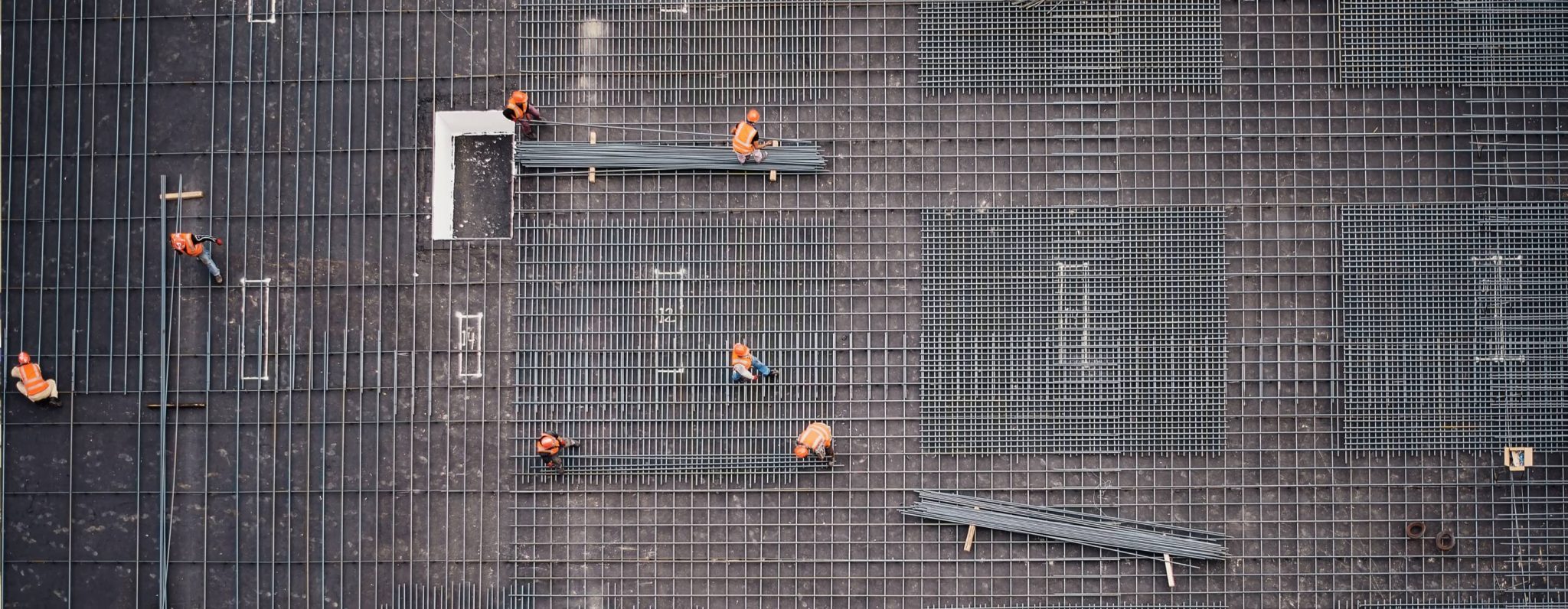 Steel bars , meshed by construction workers aerial view