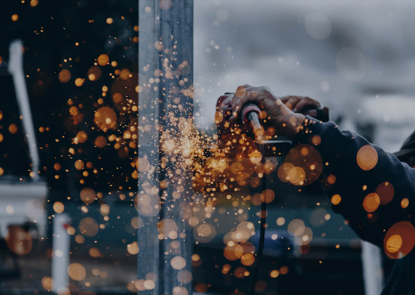 Stock image workman using grinder, sparks flying