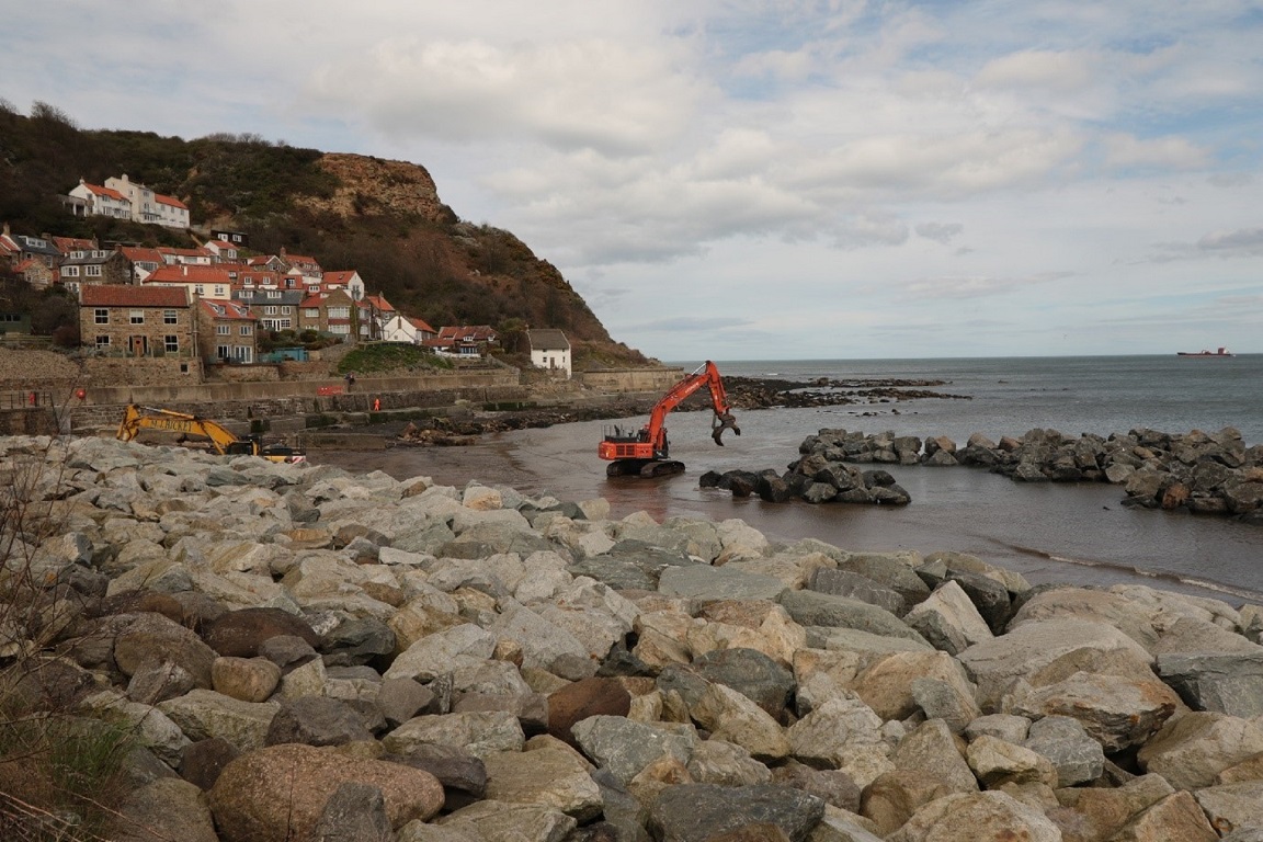 Runswick Bay Coastal Protection - image shows digger moving boulders to form the coastal defences