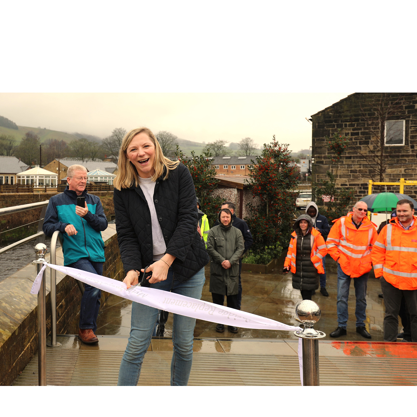 Jo Ward owner of Jo's Kitchen cutting ribbon Mytholmroyd Bridge