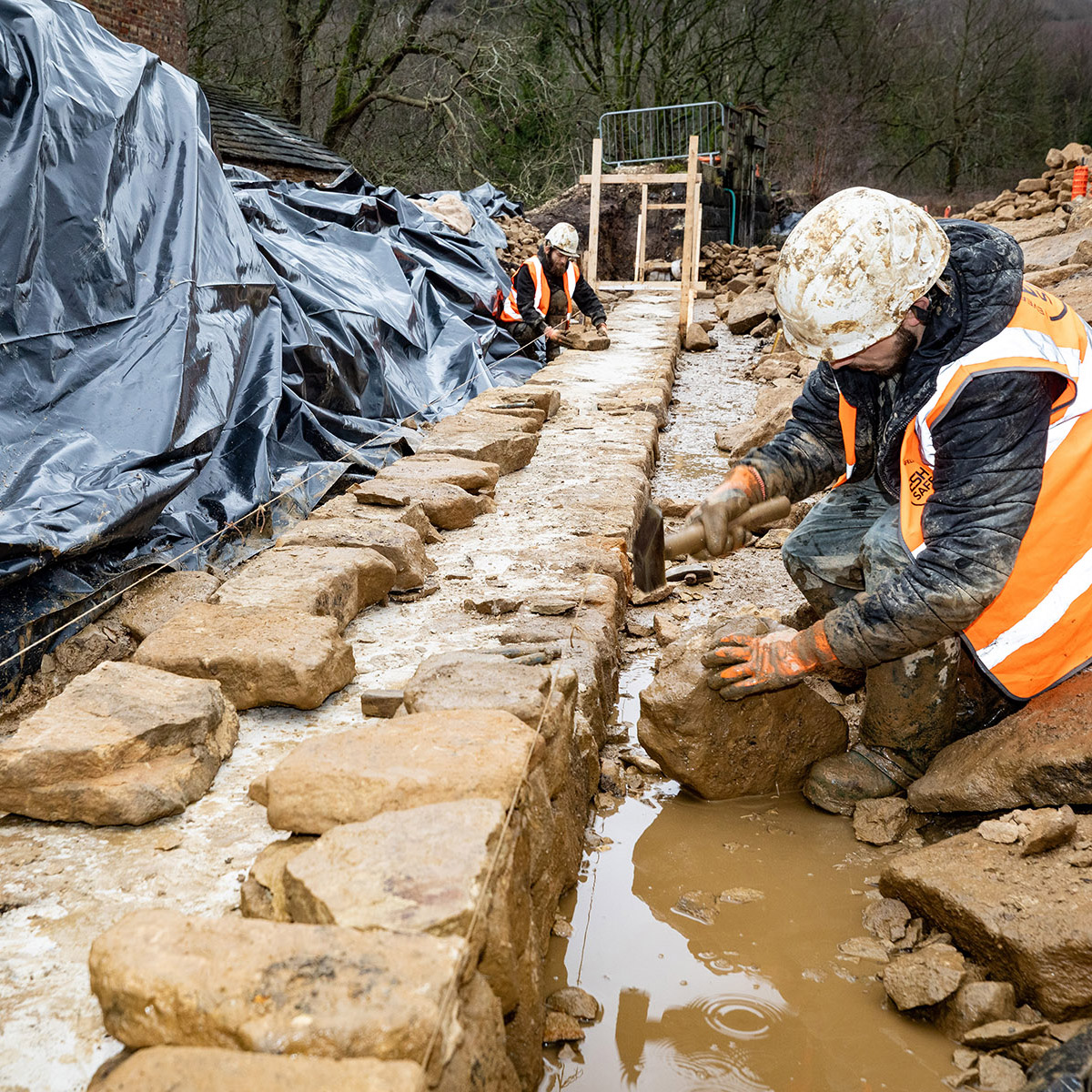 Esh staff rebuilding the retaining wall at Abbeydale Dam