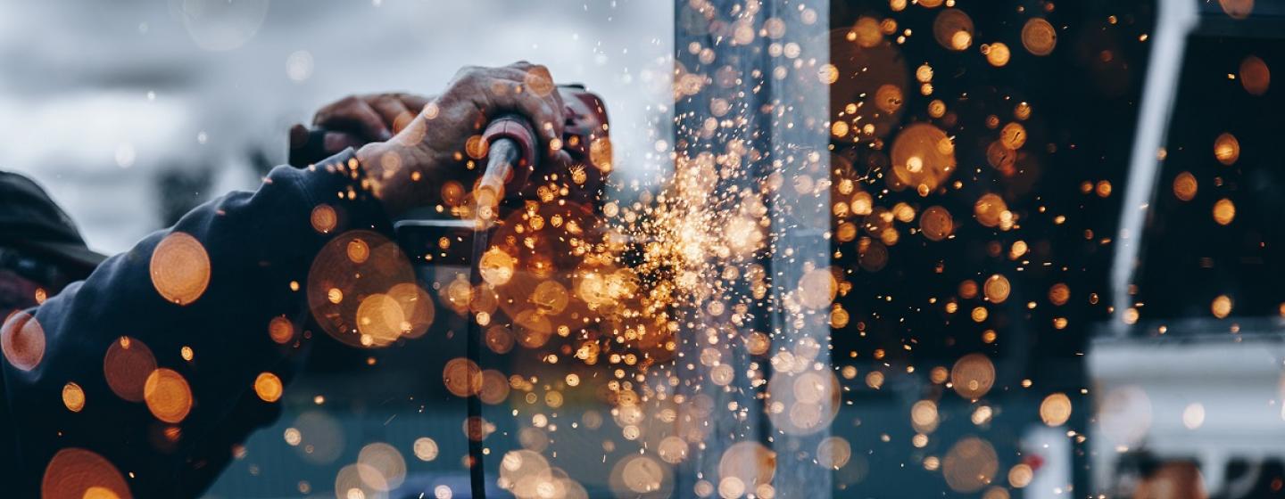 SCEP close up man's hand using grinder sending sparks close up man's hand using grinder sending sparks