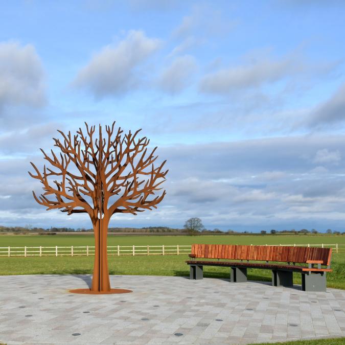 Sculptural trees with memorial leaves, engraved with messages of remembrance.
