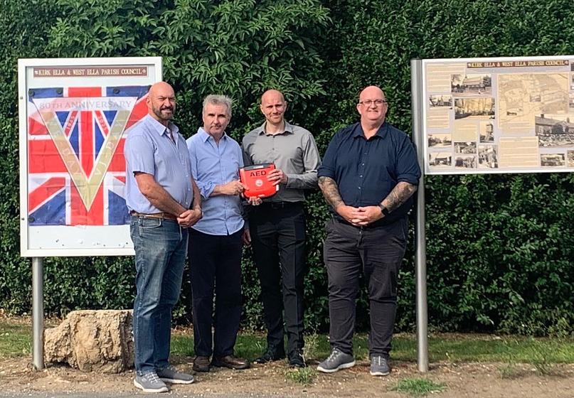 L-R Cllr Gary McMaster, Willerby and Kirk Ella Ward, Shaun Horton, Chairman, Kirk Ella & West Ella Parish Council receive their defibrillator from Dan Cawthra, Head of Stakeholder & Community Engagement, (GRAHAM), James Stevenson, Senior Project Manager, (GRAHAM).