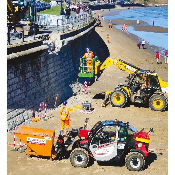 Jackson team using machinery at sea wall working at the sea wall Filey Jackson team using machinery at sea wall working at the sea wall Filey