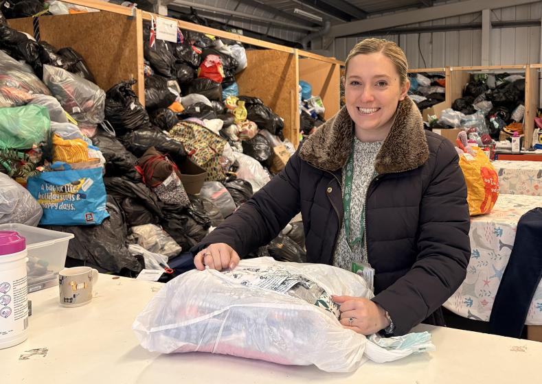 Overtgate Hospice donation centre - Megan Roberts, Social Value Manager, Esh opening donation bag